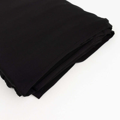 Folded black fabric on a white background