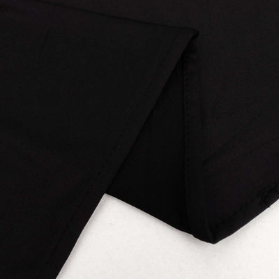 Black fabric close-up showcasing smooth texture and clean edges.