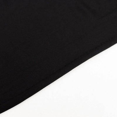 Black fabric texture close-up showing smooth surface and stitching details.