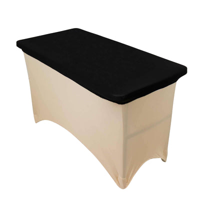 Black folding table with a cream-colored skirt