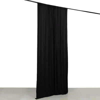 Black curtain draped from a rod for versatile room decoration