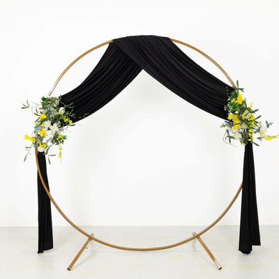 Black draped wedding arch with floral accents