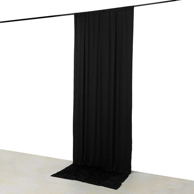 Black fabric backdrop draped from a rod, creating a smooth vertical curtain.