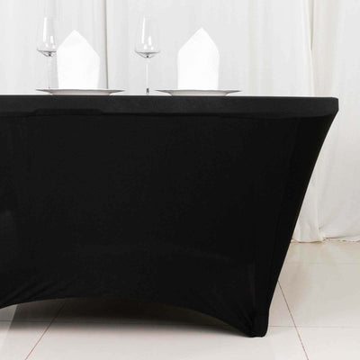 Black table cover draped elegantly for dining setup with glasses and napkins.