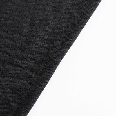 Close-up of black fabric showing texture and stitching details.
