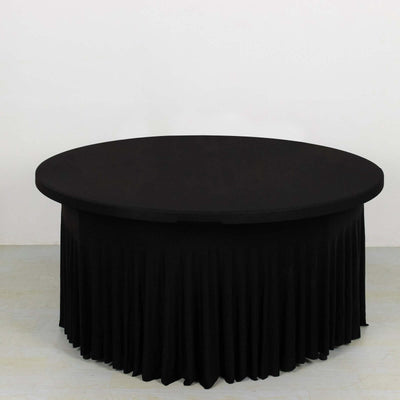 Black round table with pleated skirt, studio-style isolation shot.