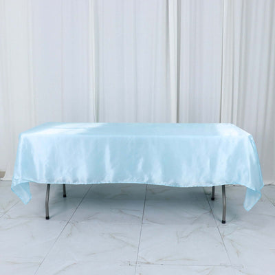 Light blue satin tablecloth on a table against a plain backdrop.