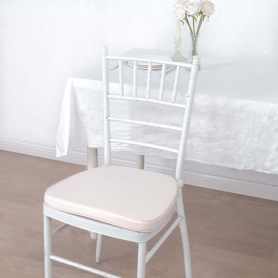 Vintage white chiavari chair with soft cream cushion in elegant dining setting.