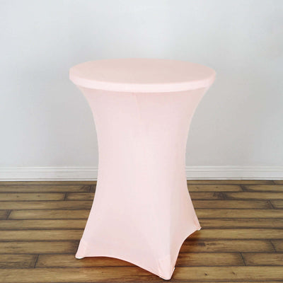 Pink stretch table cover on a round table against a plain background