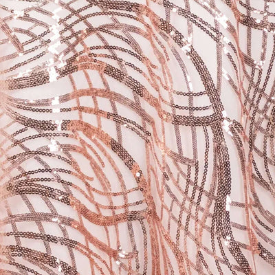 Rose gold sequin fabric with wavy pattern and shimmering texture.