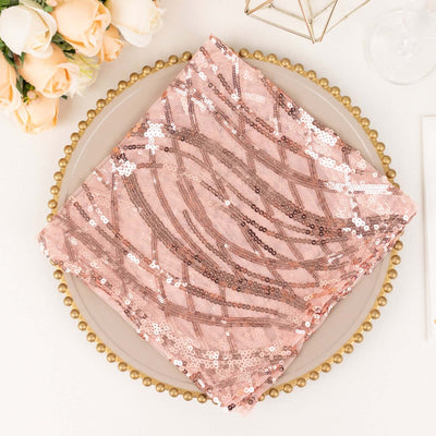 Rose gold sequin table napkin on a decorative plate.