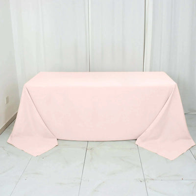 Pink tablecloth draped over a table on a white background.