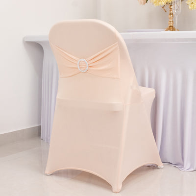 Elegant peach chair cover with decorative bow and gem accent