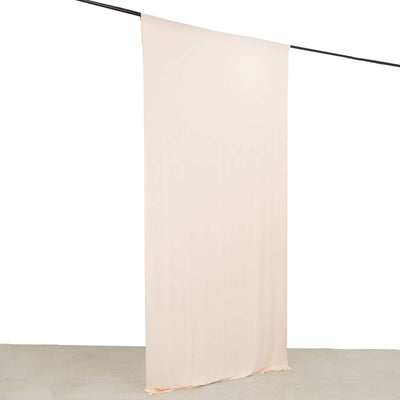 Soft beige fabric drape on a rod against a plain background