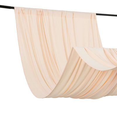Soft peach fabric draping elegantly on a black rod