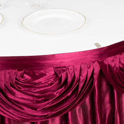 Burgundy tablecloth with pleated design over a white table