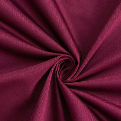 Burgundy fabric texture with a smooth, swirling pattern.