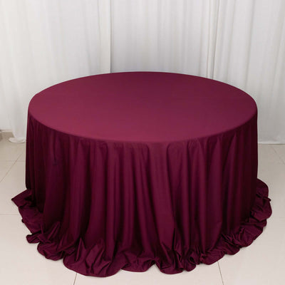 Round burgundy tablecloth with elegant draping