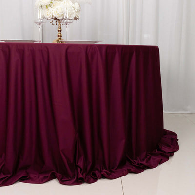 Burgundy tablecloth draped elegantly over a round table