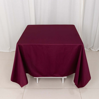 Burgundy tablecloth draped over a table in studio setting