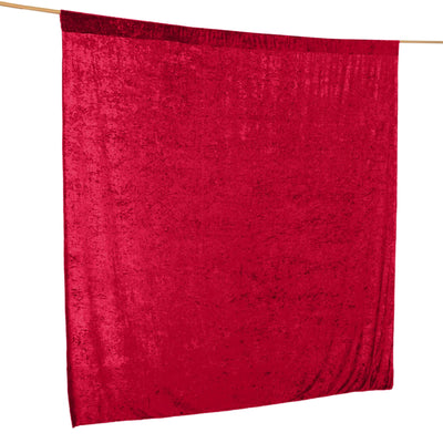 Red velvet fabric draped on a hanger for decorative use.