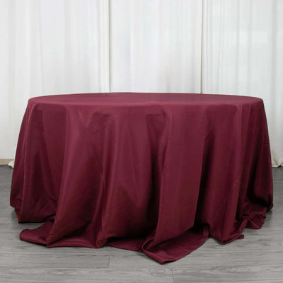 Round burgundy tablecloth draped elegantly over a table