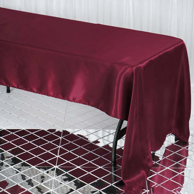 Burgundy satin tablecloth draped over a table