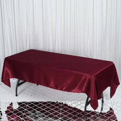 Burgundy satin tablecloth draped over a rectangular table