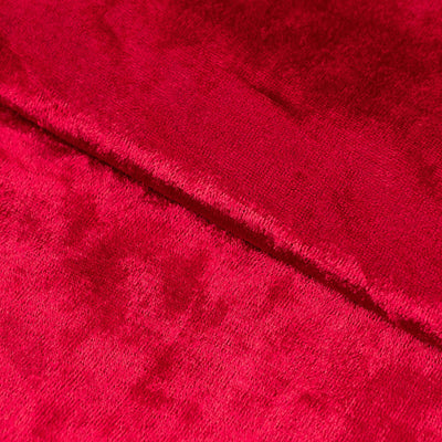 Close-up of soft red velvet fabric with rich texture.