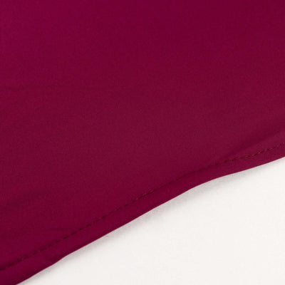 Close-up of maroon fabric showcasing smooth texture and stitching details.