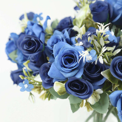 Blue rose bouquet with green leaves arranged beautifully.