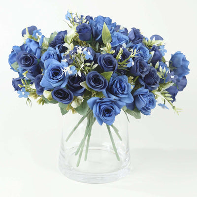 Blue rose bouquet in a clear vase, showcasing vibrant artificial flowers.