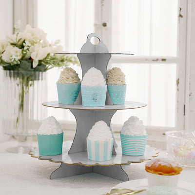 Cupcake stand with pastel blue and white cupcakes on a tiered display.
