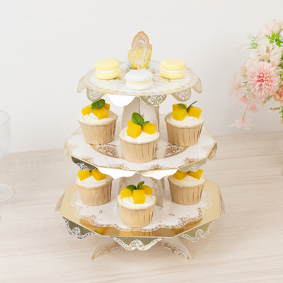 Three-tiered cupcake stand with cupcakes and macarons arranged elegantly.