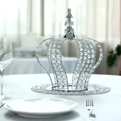 Silver crown centerpiece with crystals on a dining table.