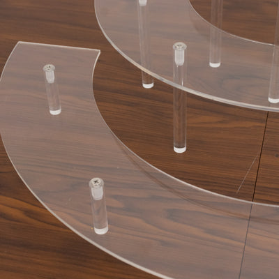 Acrylic display shelves with clear supports on a wooden surface.
