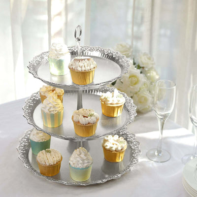 Three-tier cupcake stand adorned with various decorated cupcakes.