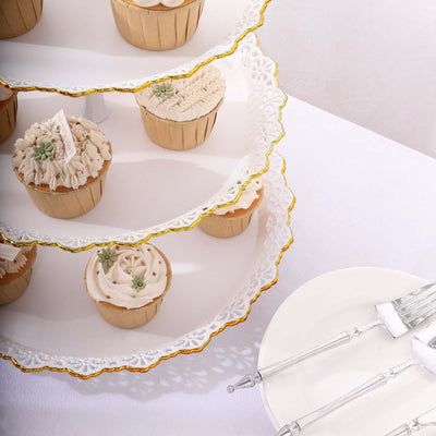 Decorative cupcakes on a tiered stand with elegant tableware.