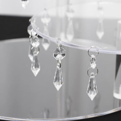 Acrylic display stand with hanging crystal accents for decorative use.