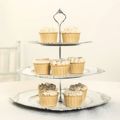Elegant three-tier cupcake stand with assorted decorated cupcakes.