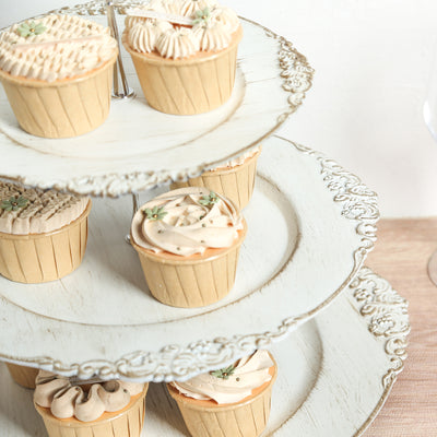 Assorted cupcakes on a decorative three-tier stand.
