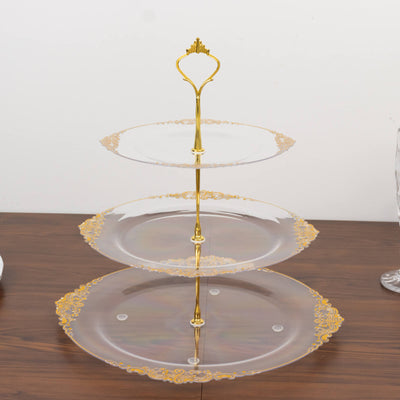 Three-tiered serving platter with gold accents on a wooden surface.