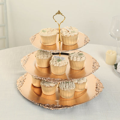 Three-tiered cupcake stand with decorative cupcakes on a table.