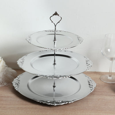 Three-tiered silver serving platter with ornate edges.