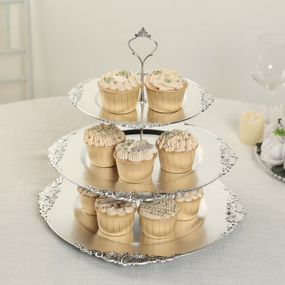Three-tiered silver cupcake stand with decorative cupcakes.
