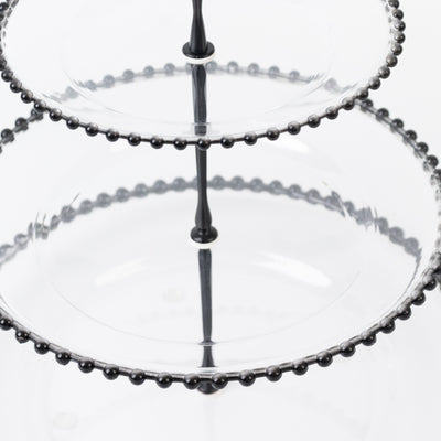 Two-tiered glass serving stand with decorative black beading.