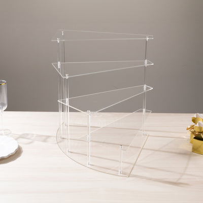 Acrylic display stand with three tiers on a light wooden surface.