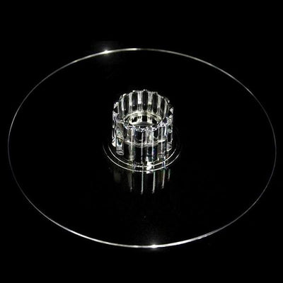 Clear glass cake stand with a decorative pedestal.
