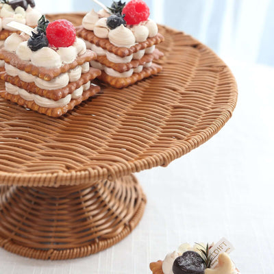 Delicious layered pastries topped with cream and berries on a woven cake stand.