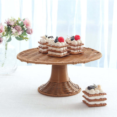 Wicker cake stand with layered desserts topped with berries and cream.